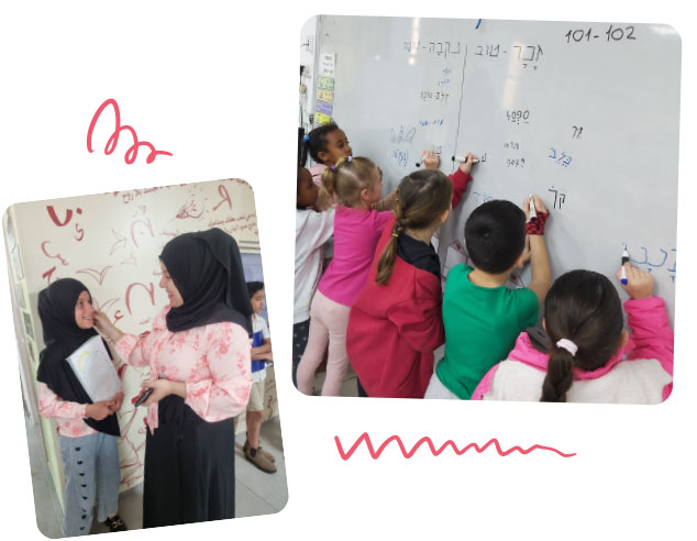 Children write on the board and a teacher gives a certificate to a student