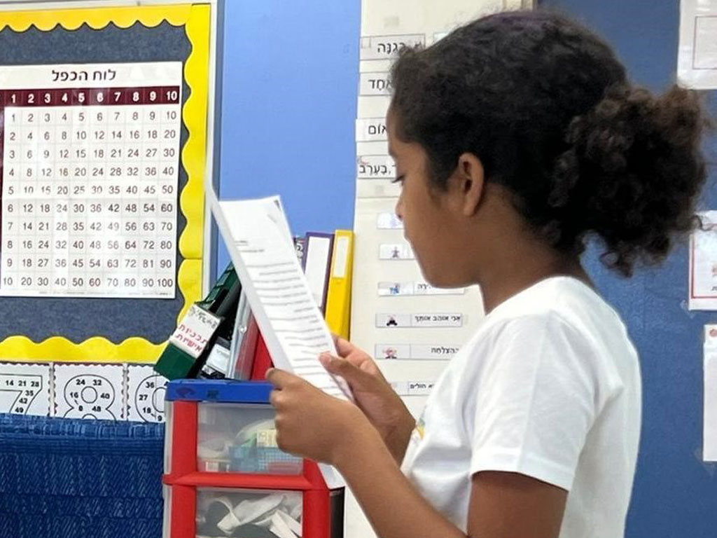 A student reads in a notebook